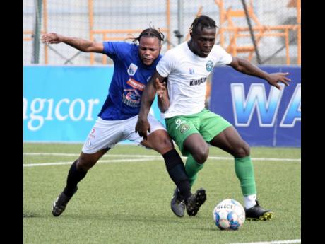 Jourdaine Fletcher (left) of Mount Pleasant and Vere United's Alton Lewis in a keen tussle for the ball during Friday's Jamaica Premier League match at the UWI-JFF Captain Horace Burrell Centre of Excellence. The game ended 0-0.