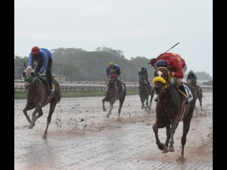 Nugent winning aboard PATRIARCH (right) at Caymanas Park.