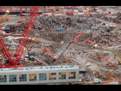 In this Friday December 21, 2001, file photo, recovery and cleanup workers and their machinery continue to clear the site of the September 11 attacks on New York’s World Trade Center.