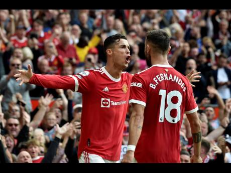 Credit: AP
Manchester United’s Cristiano Ronaldo (left) celebrates after scoring the opening goal during the English Premier League match between Manchester United and Newcastle United at Old Trafford stadium in Manchester, England, yesterday. Ronaldo scored twice