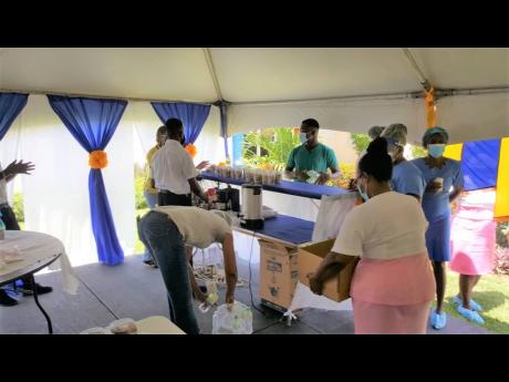 Credit: Contributed Members of staff at the Savanna-la-Mar Hospital in Westmoreland receive food items distributed by members of the Westmoreland Chamber of Commerce and Industry and the Rotary Club of Savanna-la-Mar, during both clubs’ outreach efforts to the hospital on S