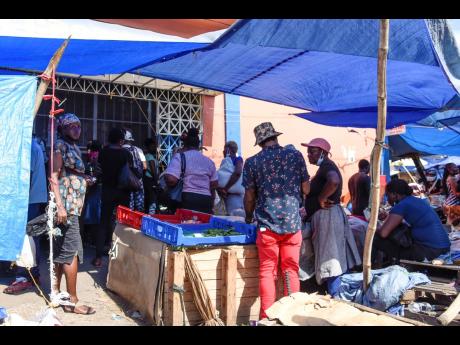 Nicholas Nunes/Photographer 
With little regard for social-distancing and mask mandates, people conduct business in a section of downtown Kingston on August 20, 2021.