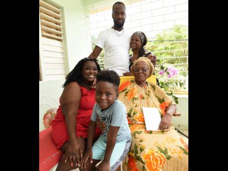 Mavis Little (right) who recently celebrated her 100th birthday, enjoys the company of relatives (from left): Rachel-Leigh Thompson, granddaughter; Jared Thompson, great-grandson; Garth Thompson, grandson, and Rushelle Whyte, granddaughter-in-law.