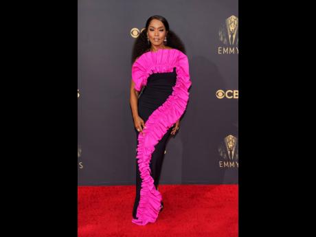‘Gunpowder Milkshake’ actress Angela Bassett brought vibrant, hot pink ruffles, to the red carpet in a statement-making dress by  Jamaican-Canadian design duo, Greta Constantine.