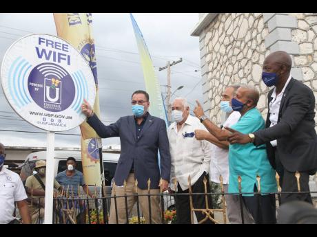 In this file photo, Minister of Science, Energy and Technology Darly Vaz, unveils a Free Wifi sign at the launch of the Universal Service Fund (USF) Free public WiFi in May Pen, Clarendon in November 2020. He was accompanied by (from left)  Member of Parli