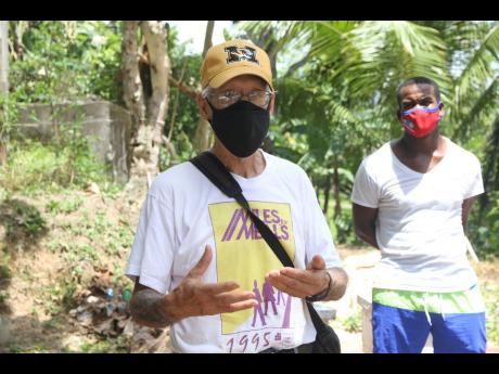 Credit: Nathaniel Stewart Dr William Zimmerman, soil microbiologist, explains some of the other products that can be obtained from beekeeping. Looking on is Darrick Grant, community development officer, Crooked River.
