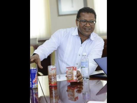 File 
Richard Pandohie, CEO of Seprod Limited, shows off some of the company’s products at his Felix Fox Boulevard office, off Marcus Garvey Drive in Kingston.
