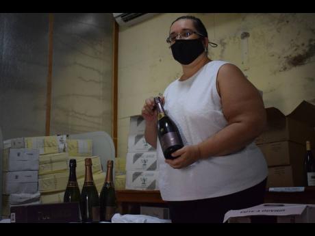 Sophie Grizzle Roumel holds a bottle of Pol Roger — the famous and exclusive French champagne favoured by the British Royal family — and imported by the Charela Inn.