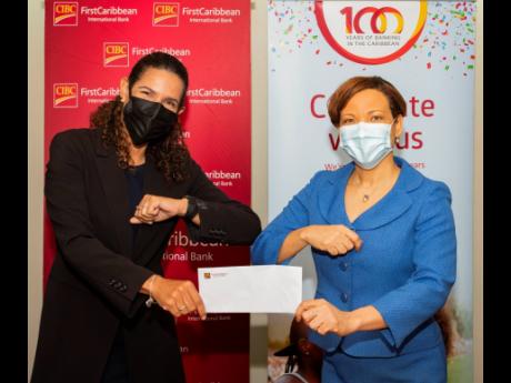 CIBC FirstCaribbean head of Corporate, Annique Dawkins (right), presents a cheque to Renee Menzies McCallum, chair, Women’s Leadership Initiative (WLI), in support of its series of workshops aimed at protecting Jamaica’s children by achieving behaviour
