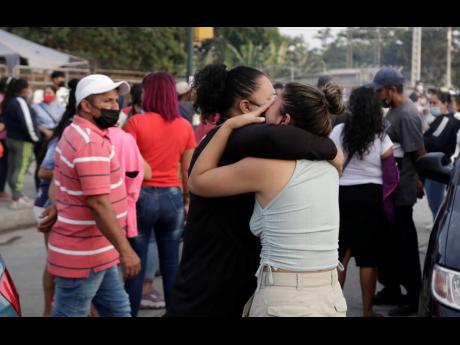 Women hug while waiting for some information about their relatives who are inmates at Litoral Penitentiary, after a prison riot, in Guayaquil, Ecuador.