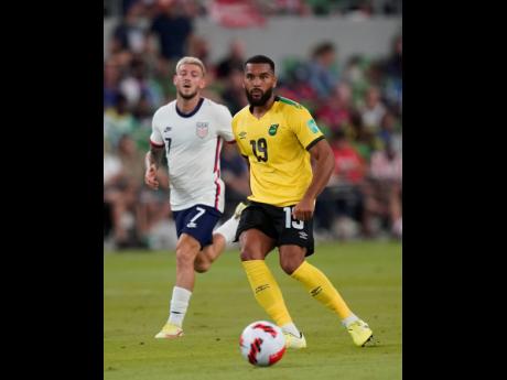 Jamaica’s Adrian Mariappa (right) and United States’ Paul Arriola during a FIFA World Cup qualifying match in Austin, Texas on Thursday.