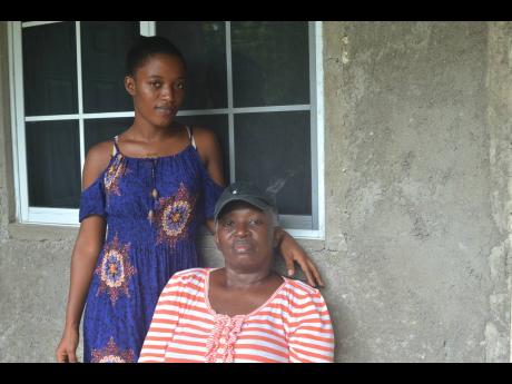Maxine Moulton-Drummond (seated) and her daughter, Rennecia Reid, at their home in Retrieve, St James. Moulton-Drummond, who is currently undergoing cancer treatment, had a mastectomy to remove her left breast in 2015.