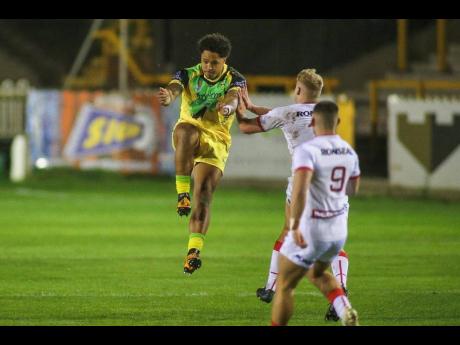  Simon Hall photo
Testimonial man Jordan Turner of the Reggae Warriors clears from defence during yesterday’s  match against the England Knights.