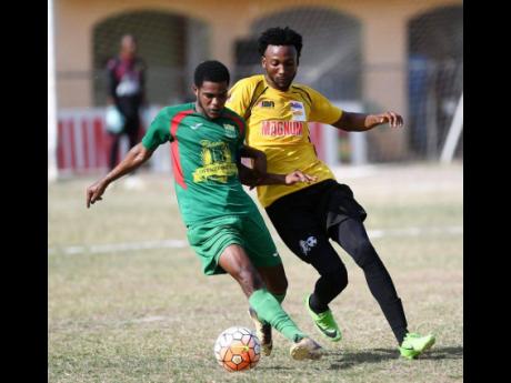 In this file photo from June 2018, Wadada defender Tyshan Hill (left) shields the ball from Barbican FC’s Cornelius Simms during their Magnum/Charley’s JB Rum/JFF Premier League playoff game at the Barbican Sports Complex.