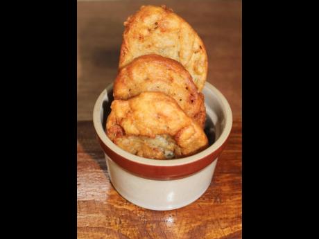 A serving of banana fritters ready to be packed for the customer that loves to start their day with a little fried breakfast pastry.