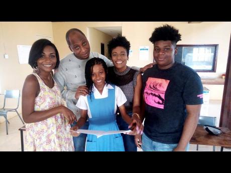 Credit: Photo by Hopeton Bucknor Jada Wright surrounded by her family (from left) aunt Denecia Salmon, father Donovan, mother Judian, and brother Jadan. The family is celebrating her success after the 11-year-old got two grade ones in the Caribbean Secondary Education Certificate exams th