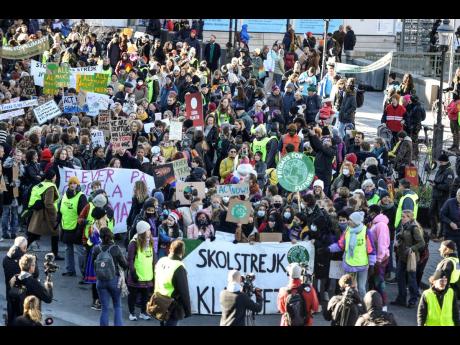 People march during a ‘global climate strike’ demonstration, organised by Fridays For Future in central Stockholm. Thousands of people marched in Stockholm on Friday for the last Global Climate Strike before COP26 opens in Glasgow. 