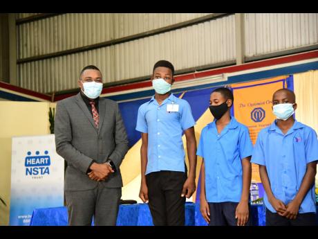 State Minister Robert Morgan poses alongside (from second left) Javaughn Barrett, Amonie Freeman, and Nandre Stewart at the launch of the Optimist International Caribbean District flagship project, ‘Mentorship for At-risk Youth’, at the YMCA in St Andr