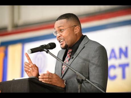 Junior Education Minister Robert Morgan speaking at the launch of the Optimist International Caribbean District’s flagship project, Mentorship for at-risk Youth, at the YMCA in Kingston on Wednesday.