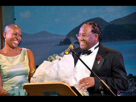 Ally Clarke says thanks with flowers to Laverne Walker of Sackville Travel, one of the sponsors of the Friends of the Caribbean charity ball.