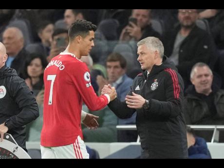 
Manchester United’s Cristiano Ronaldo (left) greets Manchester United’s manager Ole Gunnar Solskjaer as he is replaced by Marcus Rashford during the English Premier League soccer match against Tottenham Hotspur at the Tottenham Hotspur Stadium in Lond