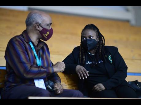 Jamaica Olympic Association President, Christopher Samuda (left), in dialogue with Netball Jamaica President Tricia Robinson during the recent Sunshine Series match against Trinidad and Tobago at the national Indoor Sports Centre.