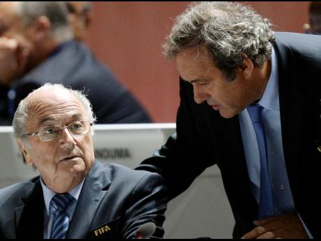 Former FIFA President Sepp Blatter (left) and former UEFA President Michel Platini are engaged in conversation during the 65th FIFA Congress held at the Hallenstadion in Zurich, Switzerland, on Friday, May 29, 2015. Swiss prosecutors have charged former FI