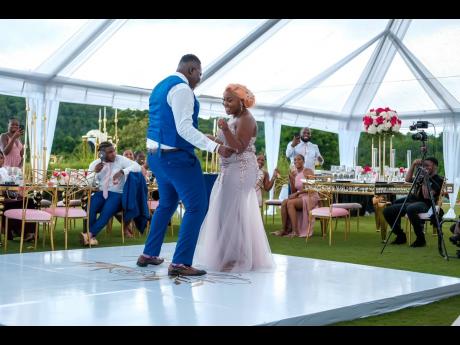 The beautiful bride, a dress change later, enjoys the loving company with her handsome groom, who ditched his jacket to join her on the dance floor. 