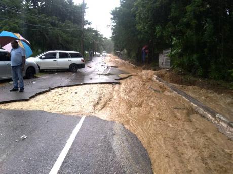 Credit: Photo by Hopeton Bucknor Torrential rain stripped the asphalt off the Unity Hall main road.