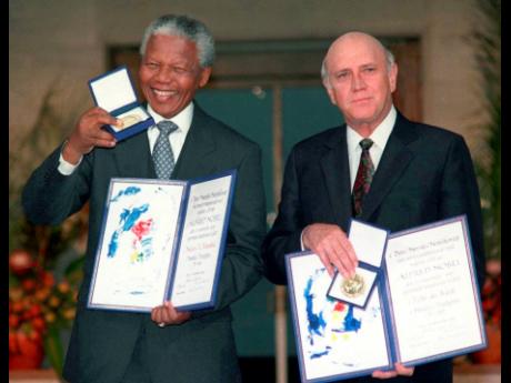 South African Deputy President F.W. de Klerk (right), and South African President Nelson Mandela pose with their Nobel Peace Prize Gold Medal and Diploma, in Oslo, December 10, 1993. F.W. de Klerk, who oversaw end of South Africa’s country’s white mino