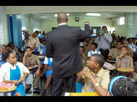 In this 2009 photo, Kevin Wallen, a director of Students Expressing Truth, speaks with fifth-form students at Ardenne High School.