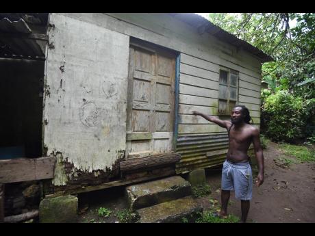 Credit: Ian Allen Sandrae Walker shows the level water from the Ital River rises to during heavy rains.Top: Ham Walk district in St Catherine North Eastern.