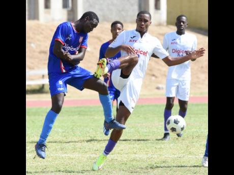 Ian Allen
Christopher Pearson (right) from Kingston College makes a dangerous tackle against Qudae Carby (left) from Clan Carthy during their Manning Cup football match at the National Stadium East playing field on Thursday. Kingston College won the game 5