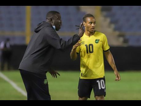 Credit: AP Jamaica’s senior men’s football team head coach, Theodore Whitmore (left), gives instructions to player Bobby Reid during the Concacaf World Cup qualifying match against El Salvador.
