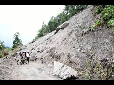 
Members of the cycling group ‘101 Riders’ near a massive landslide along the Newcastle to Hardwar Gap main road in late August. 