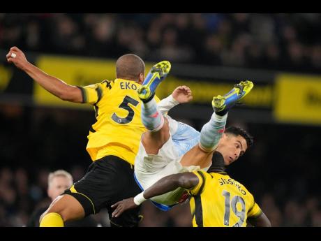 
Manchester United’s Cristiano Ronaldo (centre) duels for the ball with Watford’s William Troost-Ekong (left) and Moussa Sissoko during the English Premier League soccer match at Vicarage Road, Watford, England, yesterday. Watford won 4-1.