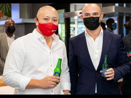 Matthew Lyn (left), chief executive officer of CB Group Limited, has a drink with Stephen Hector, group sales and marketing director of the ATL Group, during the launch of the Jamaica Food & Drink Festival and Jamaica Food & Drink Kitchen.