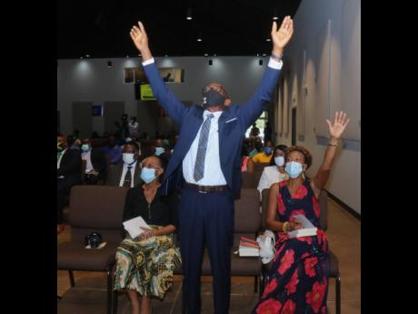 Pastor John Hines, host pastor of Abundant Life Ministries in Green Park, Trelawny, is exultant in worship during Sunday’s national church service for Local Government and Community Month.