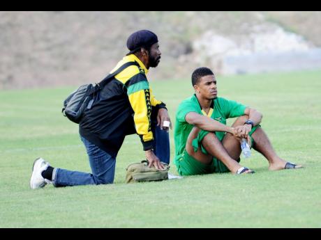 Credit: Ricardo Makyn Dr Carlton ‘Pee Wee’ Fraser (left) and Garath McCleary at the Jamaica National Football team in training at The University of the West Indies field in March 2013.