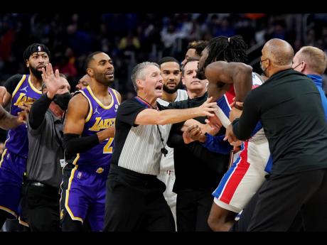 Players separate Detroit Pistons centre Isaiah Stewart from Los Angeles Lakers forward LeBron James (not in frame) during the second half of a NBA basketball game on Sunday night in Detroit.