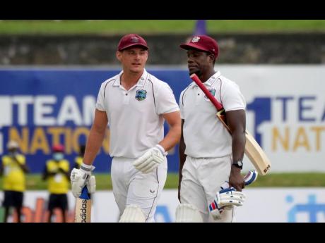 West Indies batsman Joshua Da Silva (left) and Nkrumah Bonner walk back to pavilion as the play stopped due to bad light during the fourth day's play of the first Test cricket match against Sri Lanka in Galle, Sri Lanka, today.