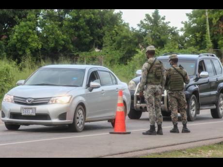Members of the Jamaica Defence Force at a checkpoint in Greenwood, St James, during the state of public emergency.