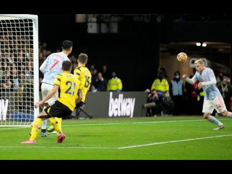 Manchester United’s Donny van der Beek (right) scores his side’s goal during their 4-1 loss in the English Premier League to Watford at Vicarage Road, Watford, England, on Saturday.