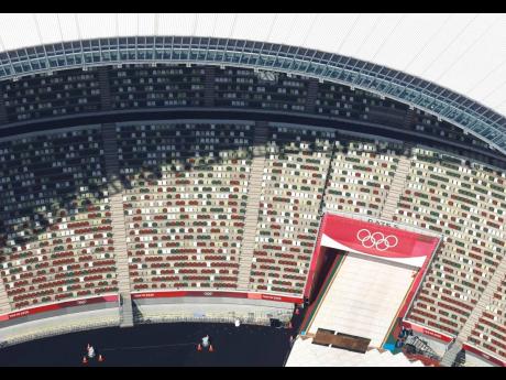 In this aerial photo, the Olympic Rings are seen with spectators’ seats at the National Stadium in Tokyo, Japan, ahead of the Tokyo Games, on Monday, June 21.