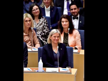 Current finance minister and Social Democratic Party leader Magdalena Andersson smiles after being appointed the new Swedish prime minister following a voting in the Swedish Parliament in Stockholm yesterday.