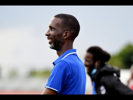 Dunoon Technical High School’s head coach, Jahmiah Pettigrew looks on during his team’s ISSA/Manning Cup football match against Excelsior High School. Excelsior High won 6-1.