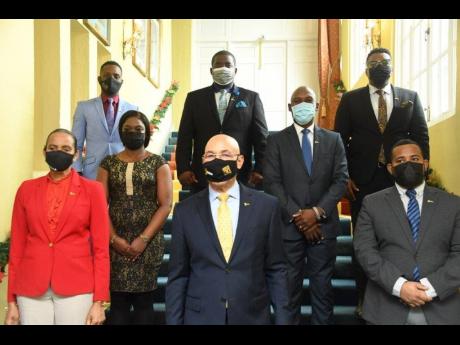 Governor General Sir Patrick Allen (centre) pauses for a photograph at King’s House with (from left), newly installed IBI Ambassadors – Claudine Heaven, Archibald Gordon, Tomori Tomlinson, Jermaine Johnson,  Nicholas Chambers, Rajae Danvers and Abrahim