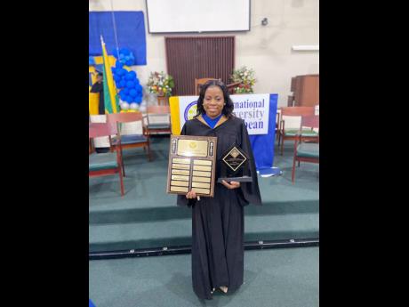 Shamoya Smith showing off some of her awards.