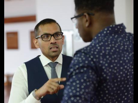 Credit: File Sports attorney Dr Emir Crowne (left) with quarter-miler Ryker Hylton on arrival at the Jamaica Conference Centre in Kingston for his anti-doping hearing on Tuesday, May 30, 2017.