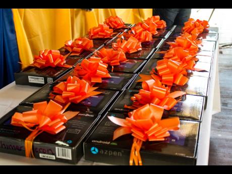Credit: Stephanie Lyew Twenty Azpen 10.1” Android tablets were distributed to grades seven and 10 students of the Tivoli Gardens High School last Tuesday.
